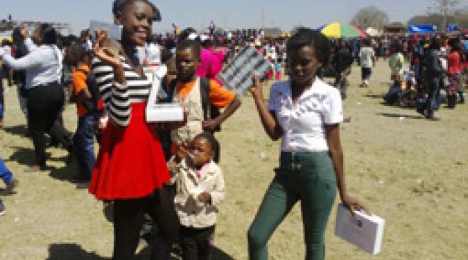 Young girls take free condoms. More than 120 000 condoms were distributed among young people at the 2014 Agricultural and Commercial Show of Zambia.