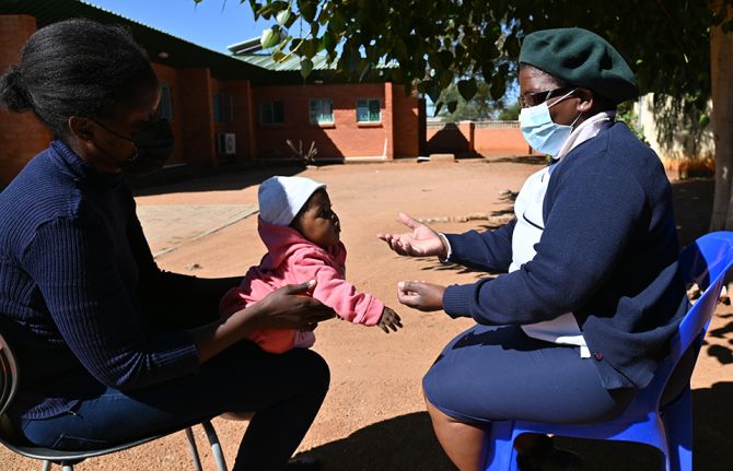 Health-care assistant Thapelo Makgokgowe visits a mother and her child in a clinic in Gaborone, Botswana, in May 2022. Health-care assistant Thapelo Makgokgowe visits a mother and her child in a clinic in Gaborone, Botswana, in May 2022.