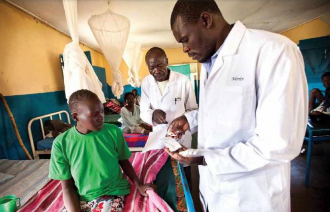 Doctors reviewing a patient's medication in a rural TB clinic, South Sudan. Credit: John Rae Photography Doctors reviewing a patient's medication in a rural TB clinic, South Sudan. Credit: John Rae Photography