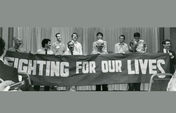 AIDS activists unfurl a banner at the National Lesbian and Gay Health conference in June 1983 in Denver. AIDS activists unfurl a banner at the National Lesbian and Gay Health conference in June 1983 in Denver.