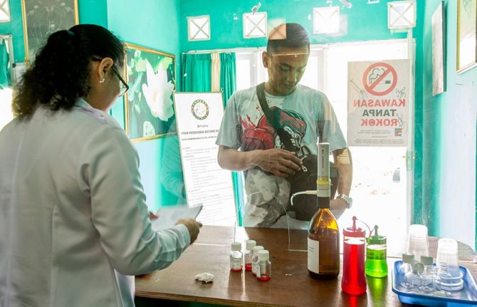A community health worker picks up a five-day supply of methadone for clients, who can then access their daily dose at Rumah Singgah PEKA, a community-based harm reduction programme in Indonesia. PEKA, which aims to empower people who use drugs to re-est A community health worker picks up a five-day supply of methadone for clients, who can then access their daily dose at Rumah Singgah PEKA, a community-based harm reduction programme in Indonesia. PEKA, which aims to empower people who use drugs to re-est